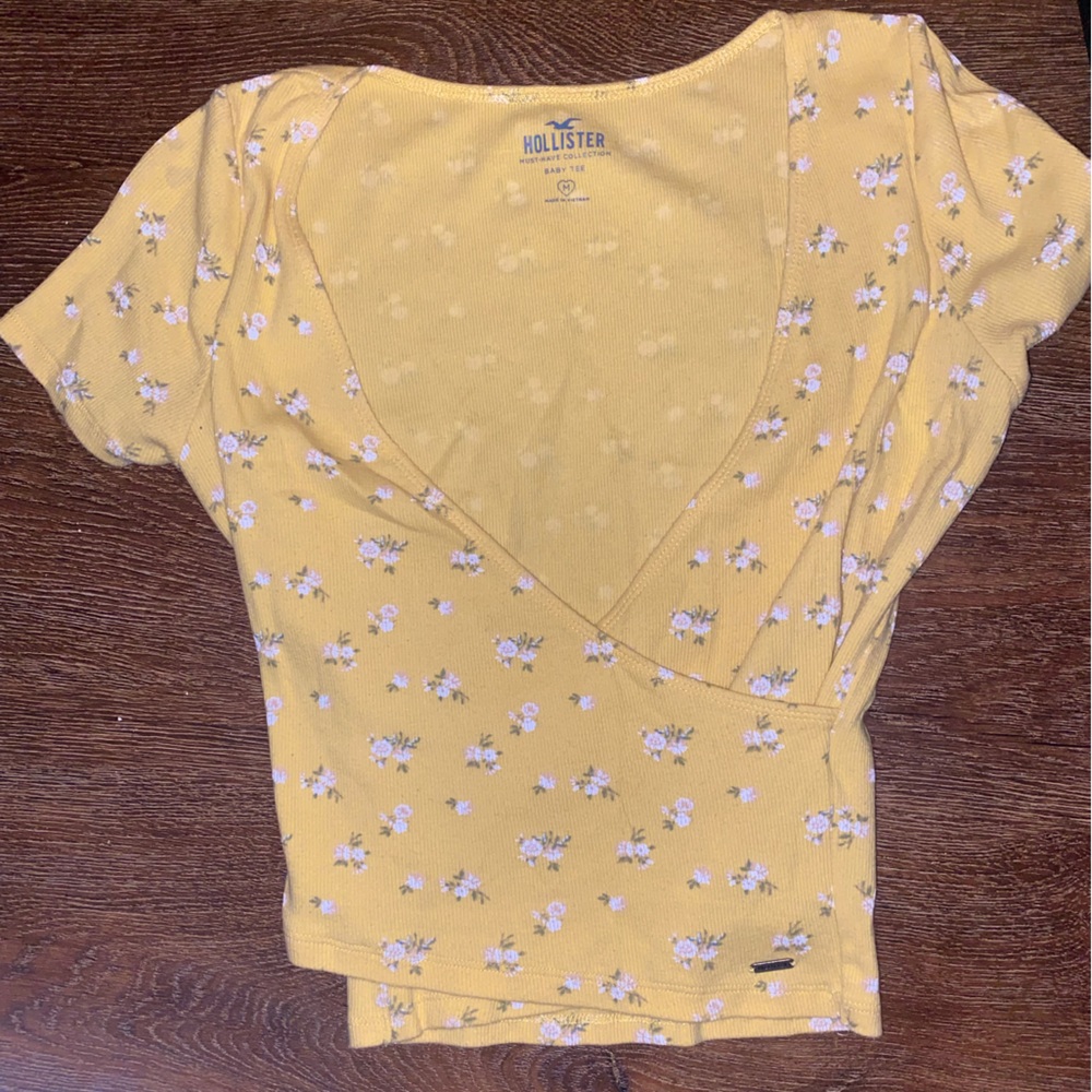 Yellow holistic shirt with flowers , size medium.